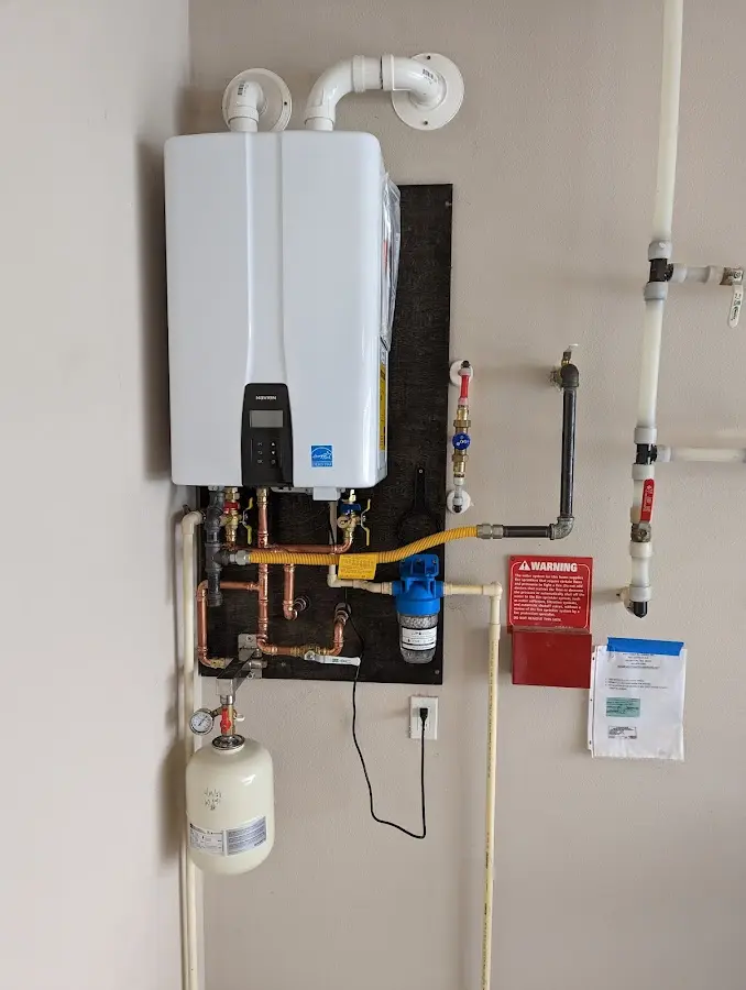 Professional plumber installing copper piping in a Tyrone home